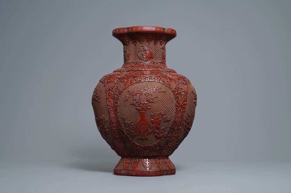 A Chinese carved cinnabar lacquer vase, Qianlong mark, 19/20th C.