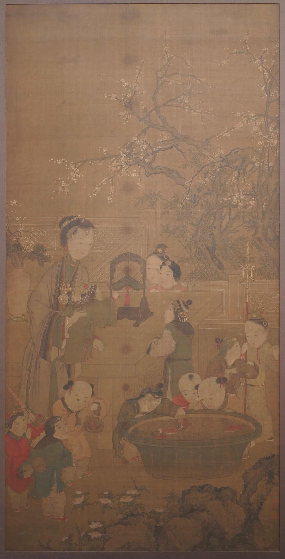 Chinese school, after Su Hanchen (1094-1172), ink and colour on silk: a lady and children near a fish bowl