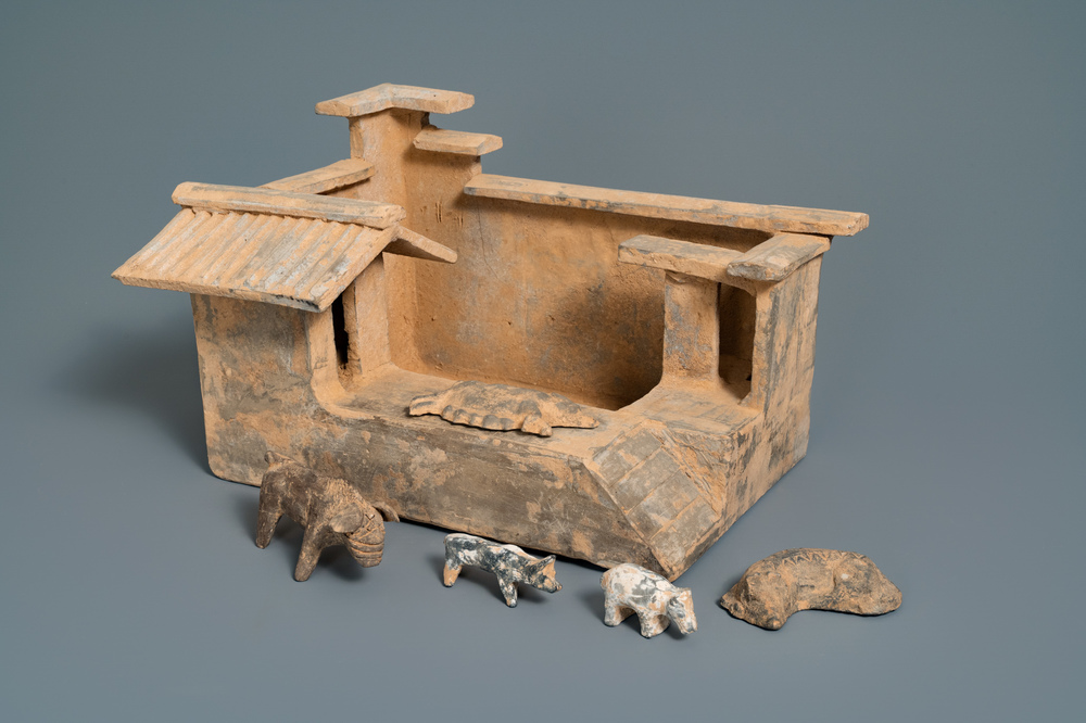 A Chinese earthenware model of a stable and five animals, Han
