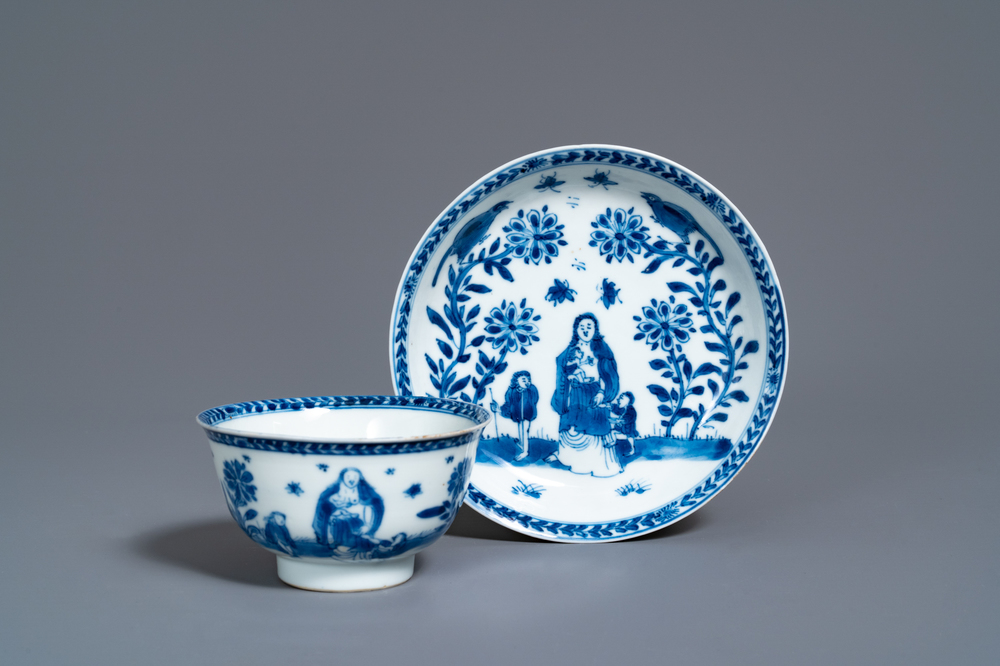 A Chinese blue and white 'mother with child' cup and saucer, Kangxi