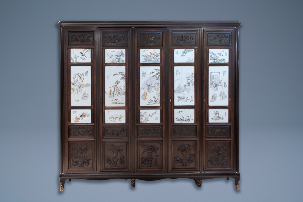 A Chinese wooden closet with 23 qianjiang cai plaques, 19/20th C.
