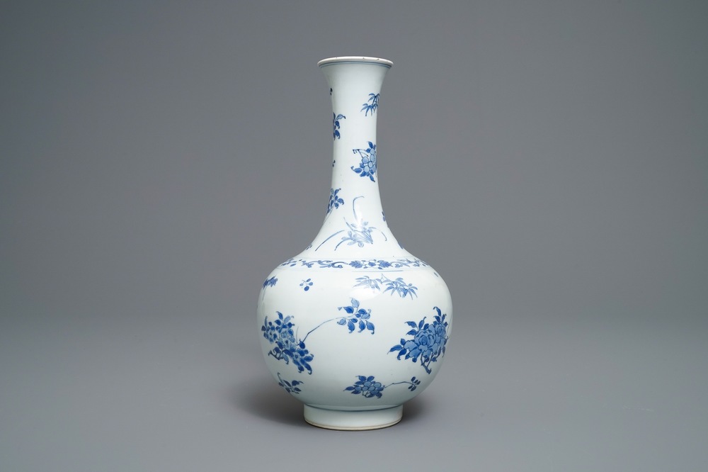 A Chinese blue and white bottle vase with floral design, Transitional period