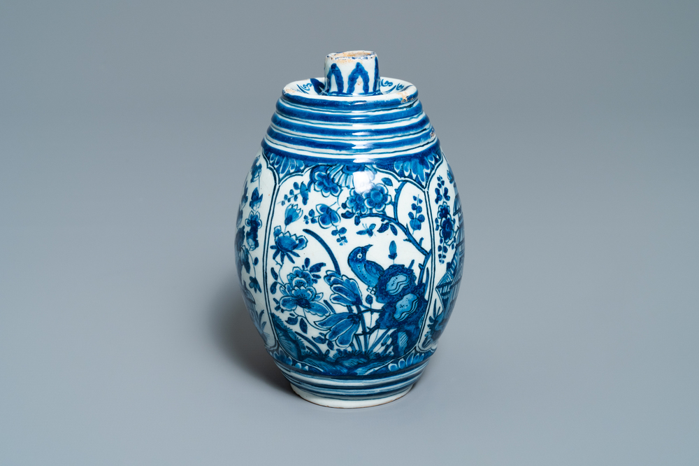 A Dutch Delft blue and white barrel-shaped gin flask with chinoiserie design, dated 1711