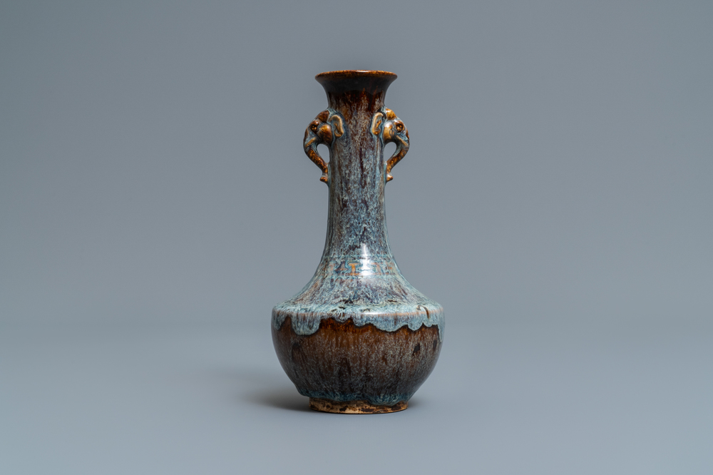 A Chinese flamb&eacute;-glazed vase with elephant head handles, 18/19th C.