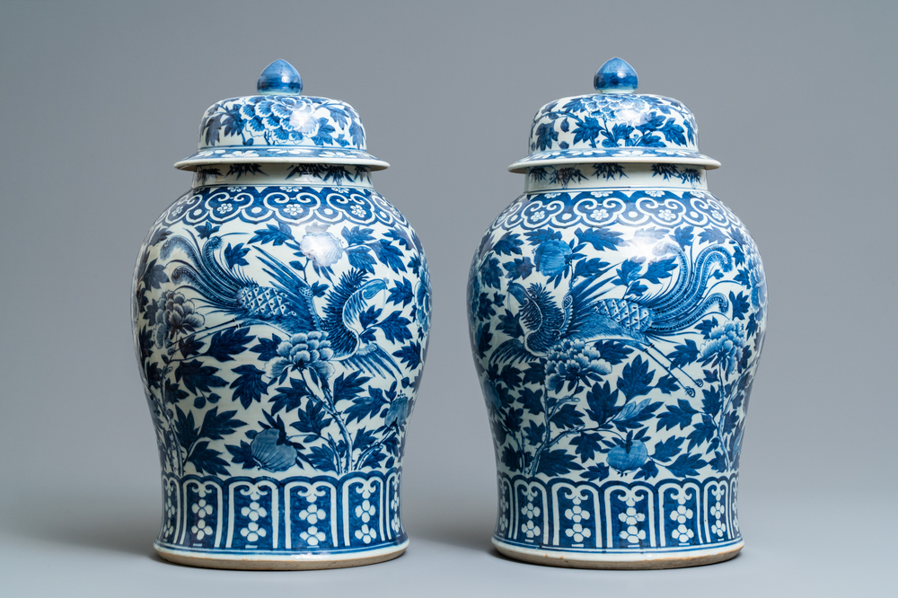 A pair of Chinese blue and white vases and covers with phoenixes, 19th C.