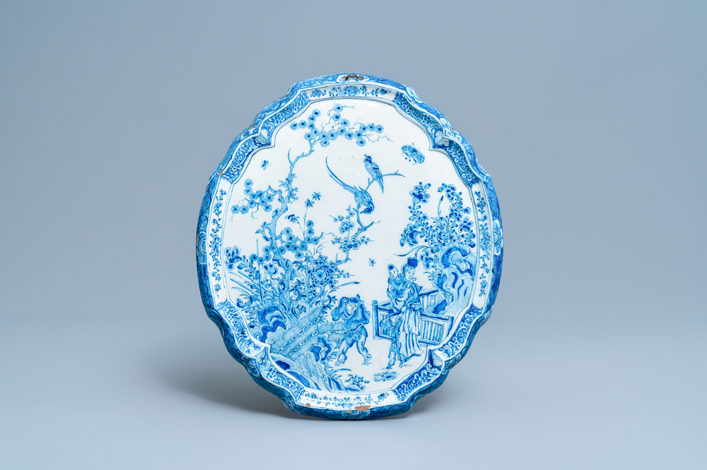 A Dutch Delft blue and white chinoiserie plaque with figures in a garden, 18th C.