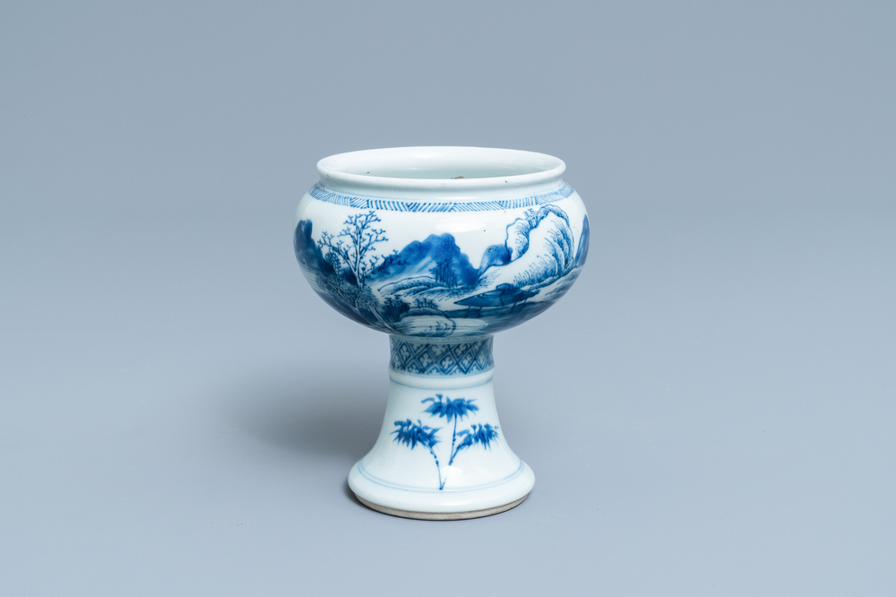 A Chinese blue and white stem cup with a continuous landscape scene, Kangxi/Yongzheng
