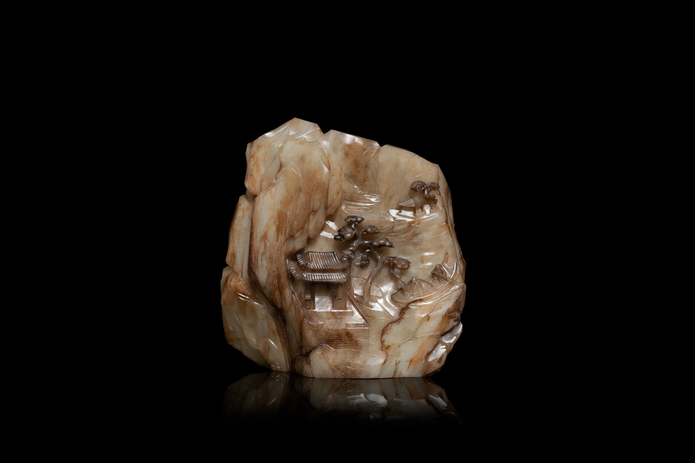 A Chinese mottled white jade mountain landscape with a fishing boat, Qing