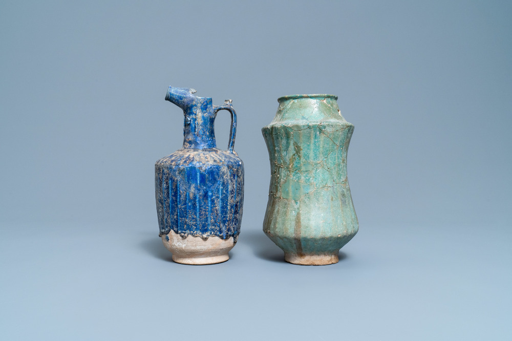 A turquoise-glazed Islamic pottery albarello and a blue-glazed ewer, Iran or Syria, 12/13th C.