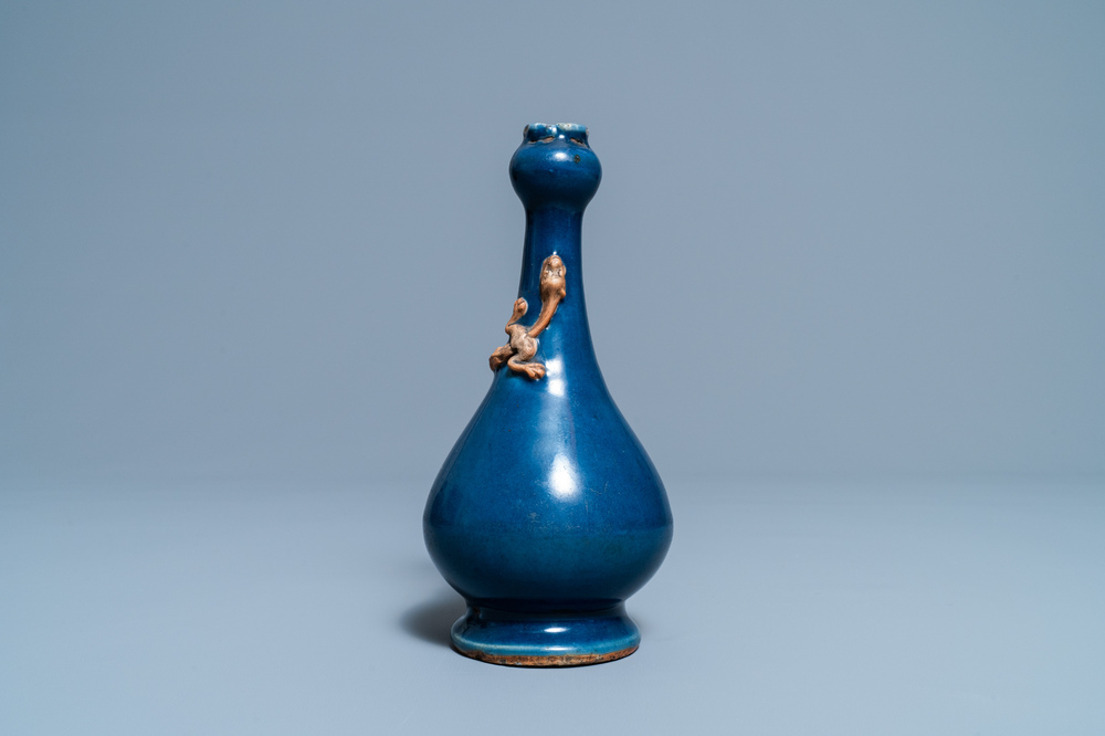 A Chinese monochrome blue garlic head vase with applied biscuit dragon, Jiajing