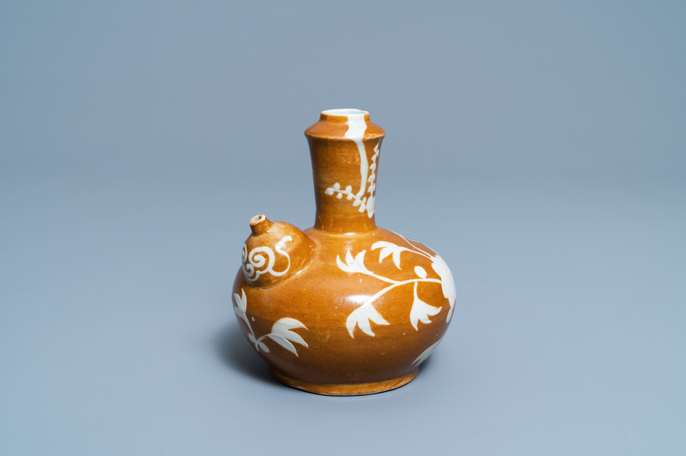 A rare Chinese slip-decorated brown-ground Swatow kendi, Ming