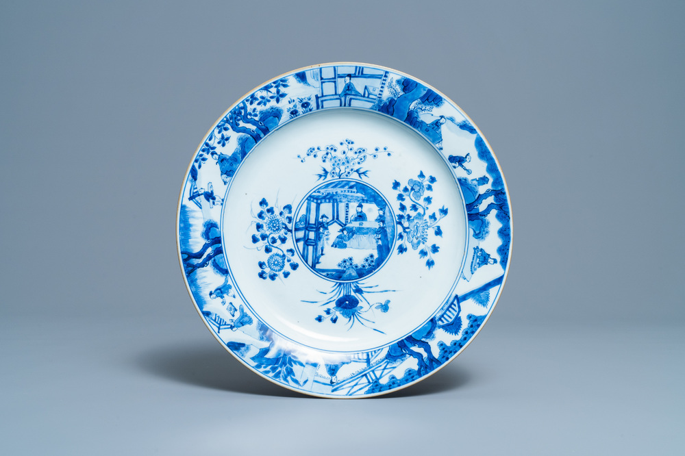A Chinese blue and white dish with raised central medallion, Kangxi