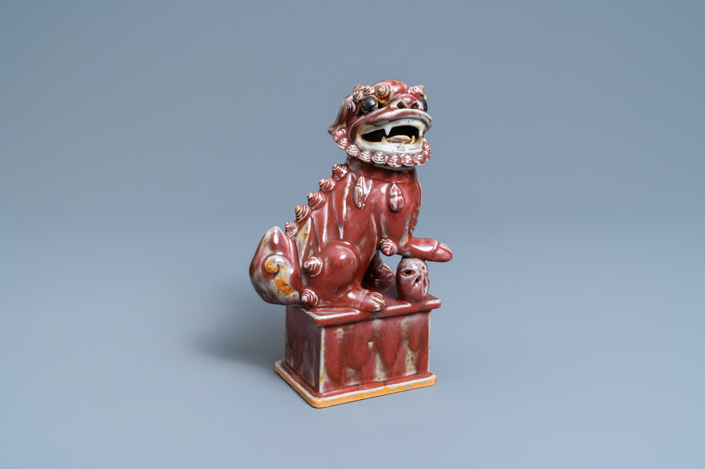 A Chinese monochrome sang de boeuf model of a Buddhist lion, 19th C.