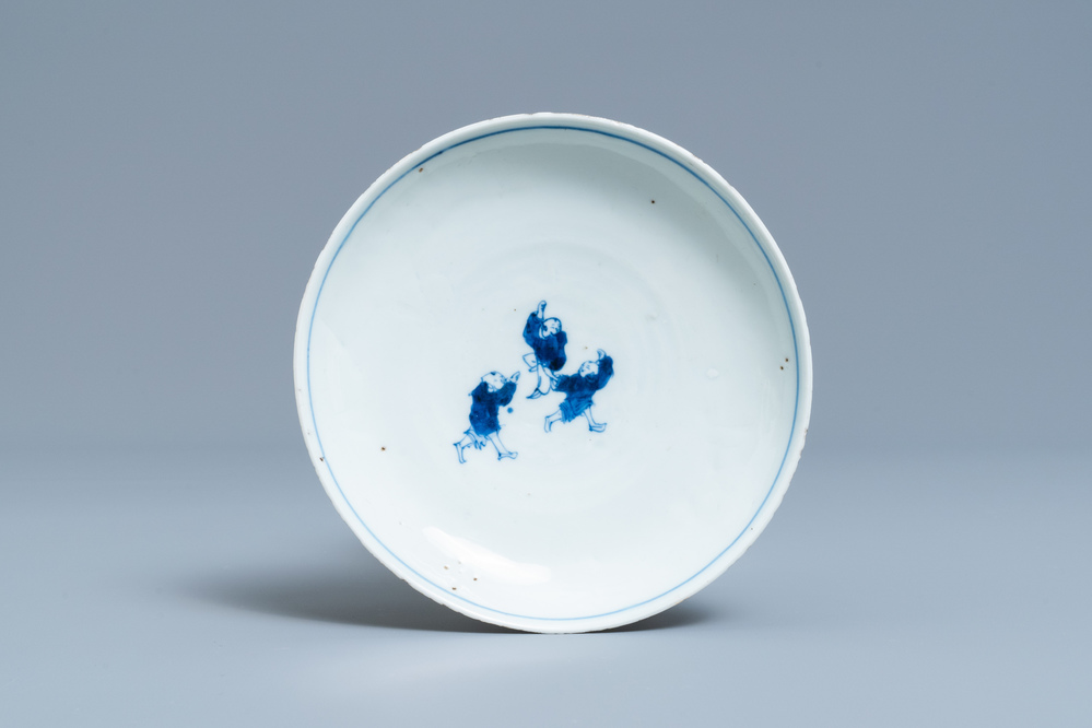 A Chinese blue and white ko-sometsuke plate with three playing boys for the Japanese market, Transitional period