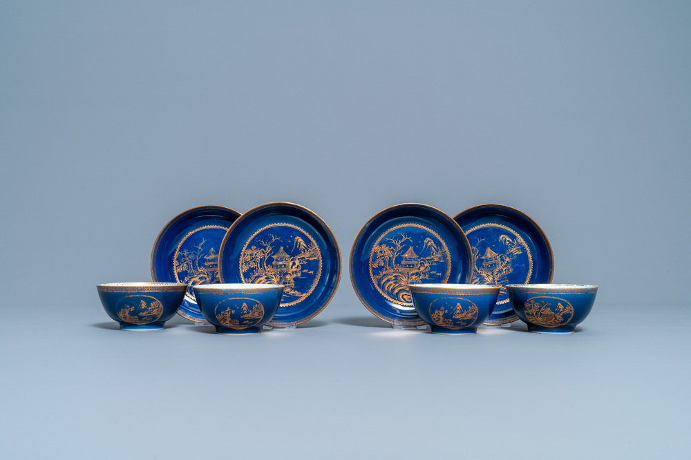 Four Chinese gilt-decorated blue-ground cups and saucers with fine landscapes, Qianlong