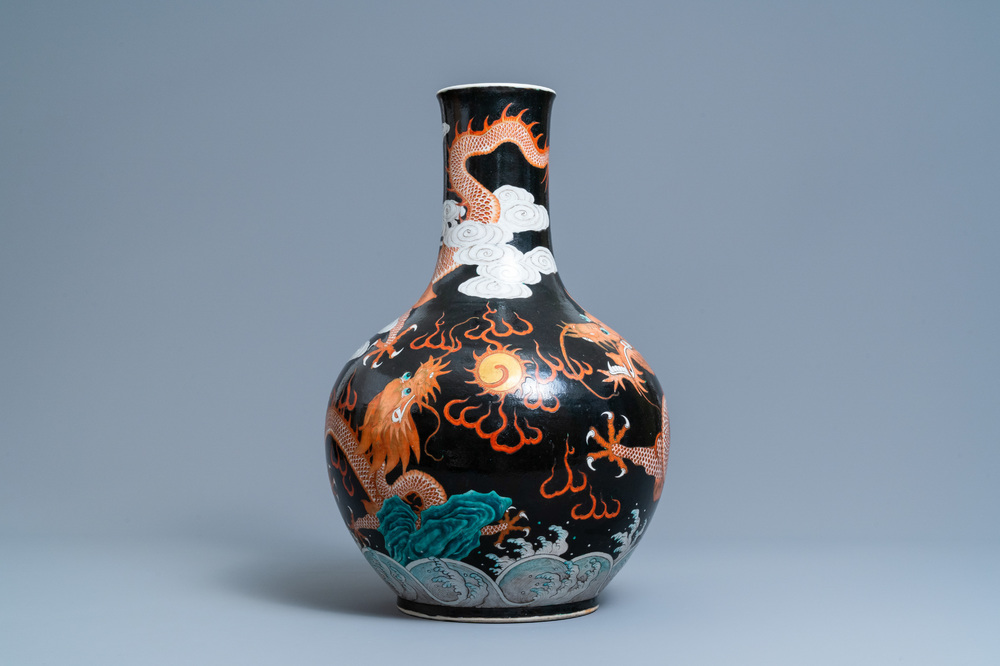 A Chinese famille noire 'dragon' bottle vase, 19th C.