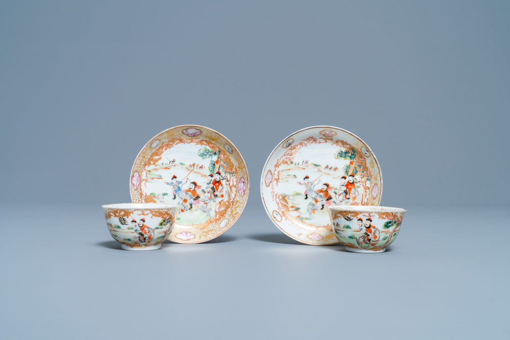 A pair of Chinese gilded famille rose 'Mongolian hunt' cups and saucers, Qianlong