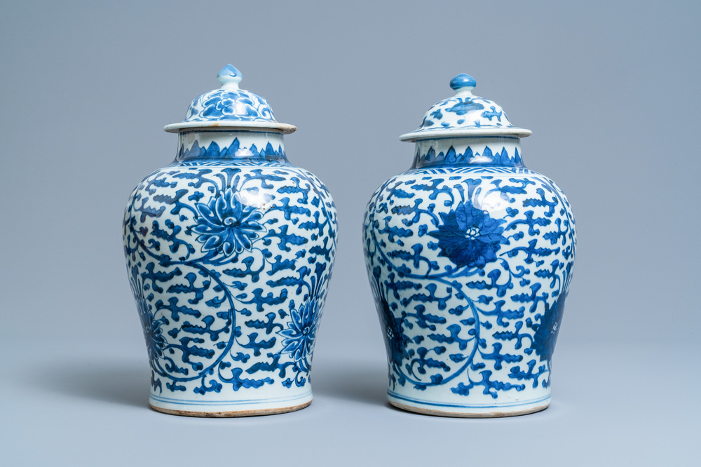 A pair of Chinese blue and white 'lotus scroll' vases and covers, Kangxi