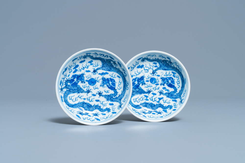 A pair of Chinese blue and white 'dragon' saucers, Kangxi mark, 19th C.