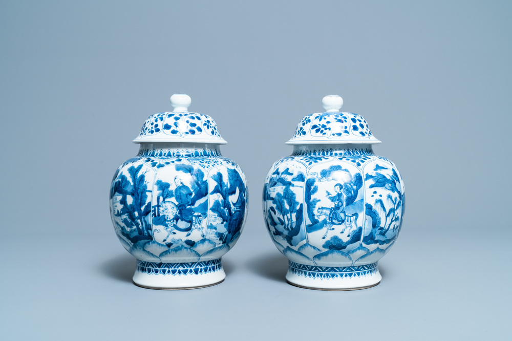 A pair of Chinese blue and white 'hunting scene' jars and covers, Kangxi