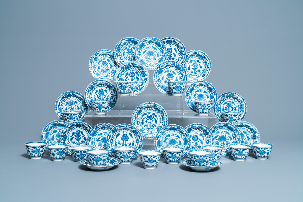 Seventeen Chinese blue and white cups and twenty-two saucers with floral design, Kangxi