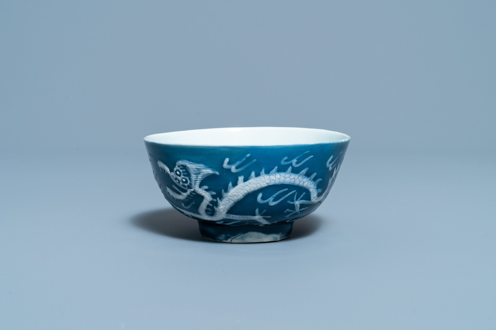 A Chinese white slip-decorated blue-ground 'dragon' bowl, Yu Tang Jia Qi mark, Wanli