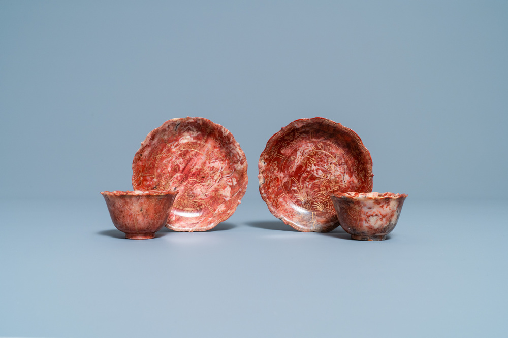 A pair of Chinese Shoushan soapstone gilt-decorated engraved cups and saucers, Kangxi