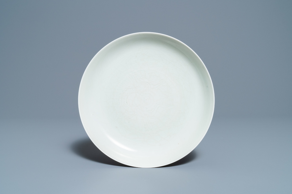 A Chinese monochrome celadon underglaze 'dragon' dish, Qianlong/Jiaqing