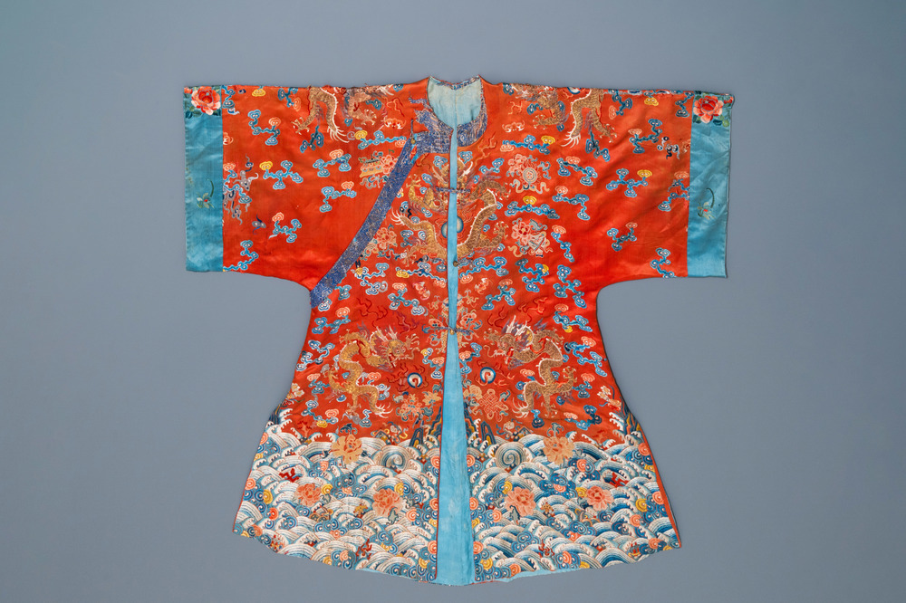 A Chinese embroidered silk red-ground 'dragon' robe, 19th C.