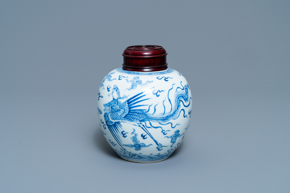 A Chinese blue and white 'dragon and phoenix' jar with wooden lid, Chenghua mark, Kangxi
