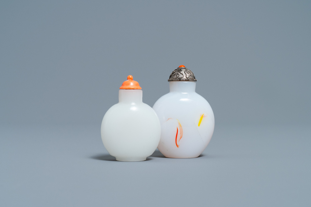A Chinese white jade coral-topped snuff bottle and one in glass with inclusions, 19th C.