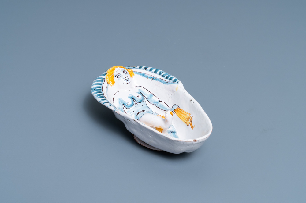 A polychrome faience oval footed bowl with a bathing woman, France, 17th C.