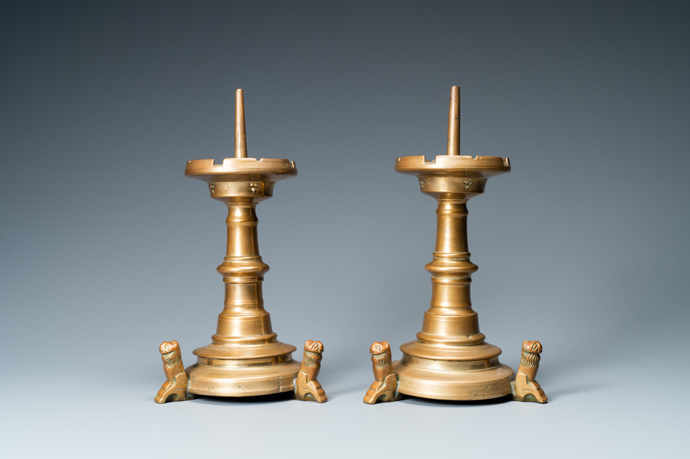 A pair of brass alloy candlesticks on lion feet, The Netherlands, 1st half 15th C.