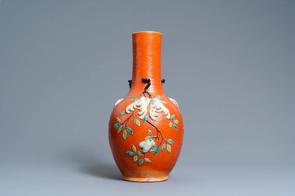 A Chinese famille rose 'sanduo' vase with applied design on a coral red ground, 19th C.