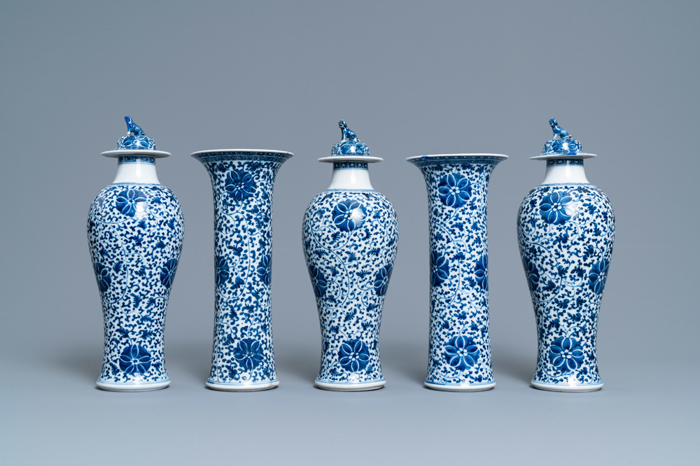 A Chinese blue and white five-piece garniture with floral design, 19th C.