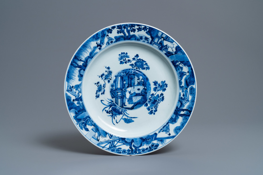 A Chinese blue and white dish with raised central medallion, Kangxi