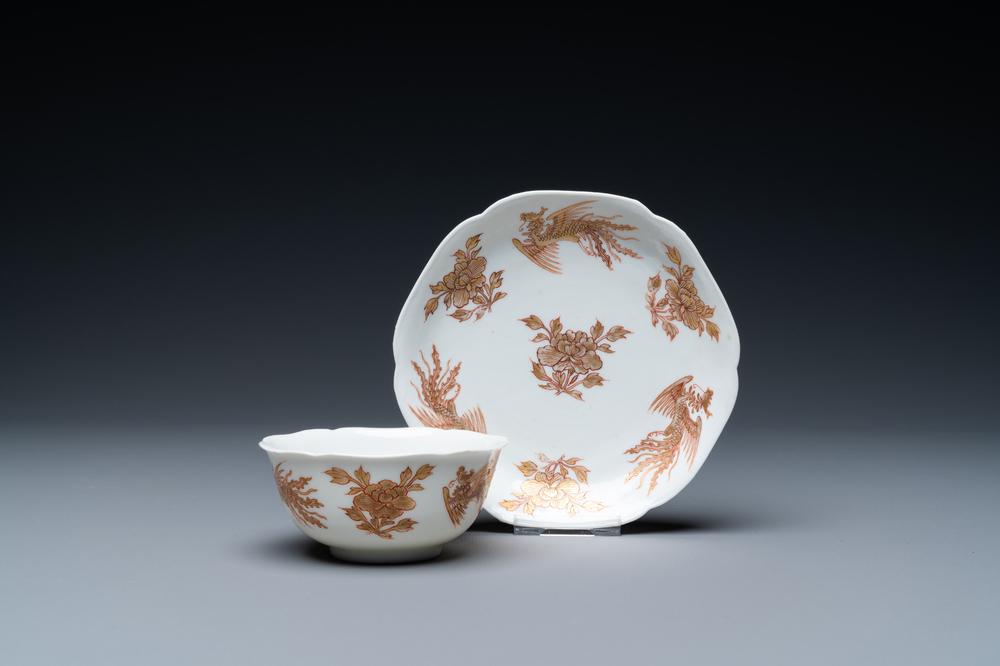 A Chinese iron-red and gilt 'phoenixes' cup and saucer, Kangxi