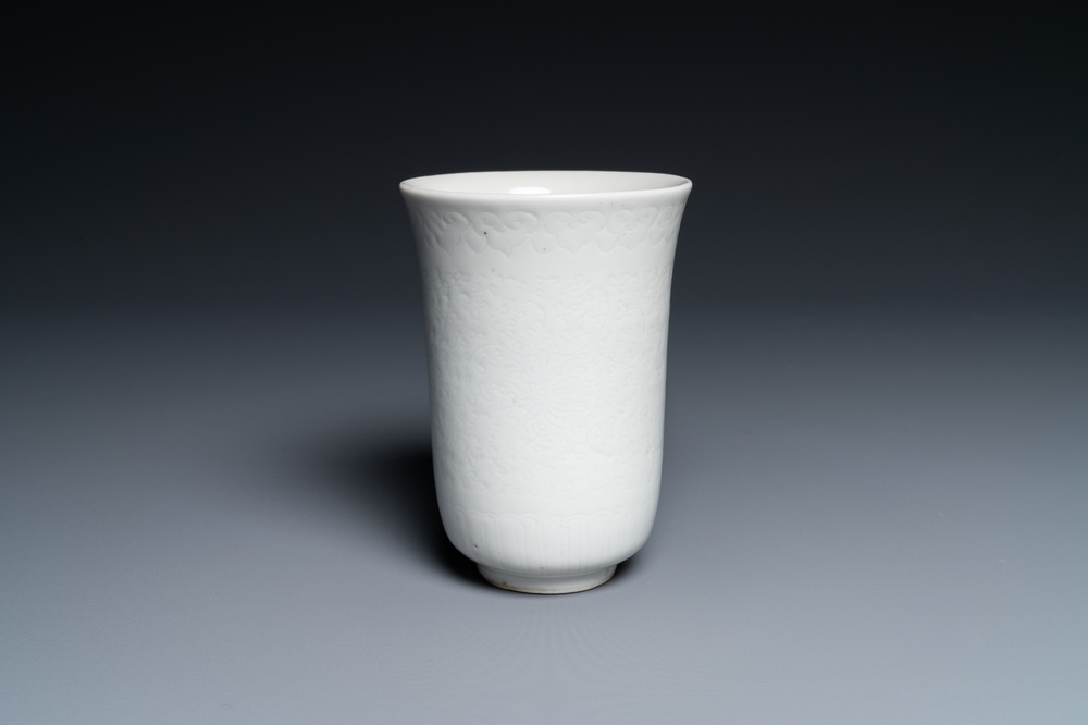 A Chinese white-glazed anhua-decorated 'peony' cup, Xuande mark, Kangxi