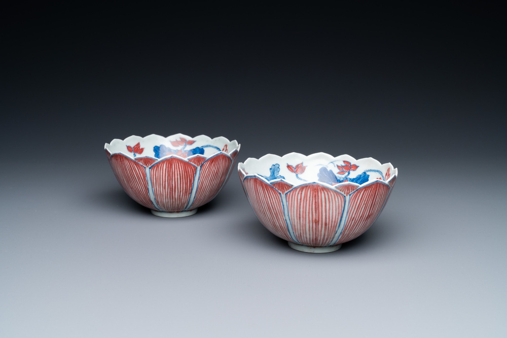A pair of Chinese blue, white and copper-red 'lotus' bowls, Kangxi mark, 19th C.