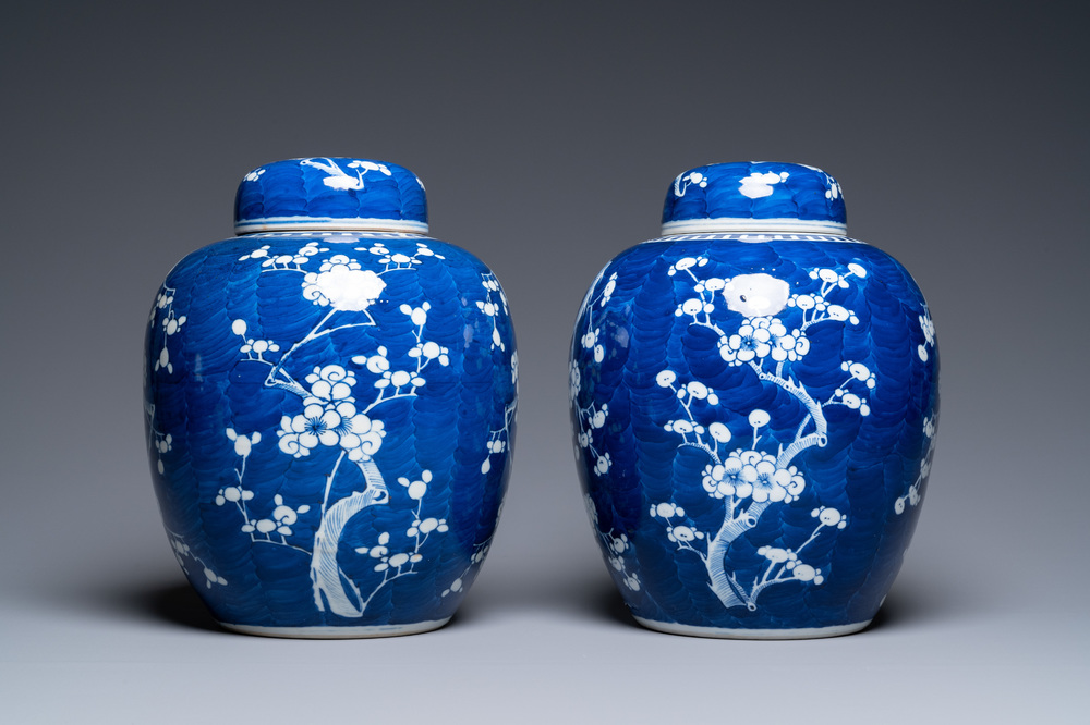 A pair of large Chinese blue and white 'prunus' jars and covers, 19th C.