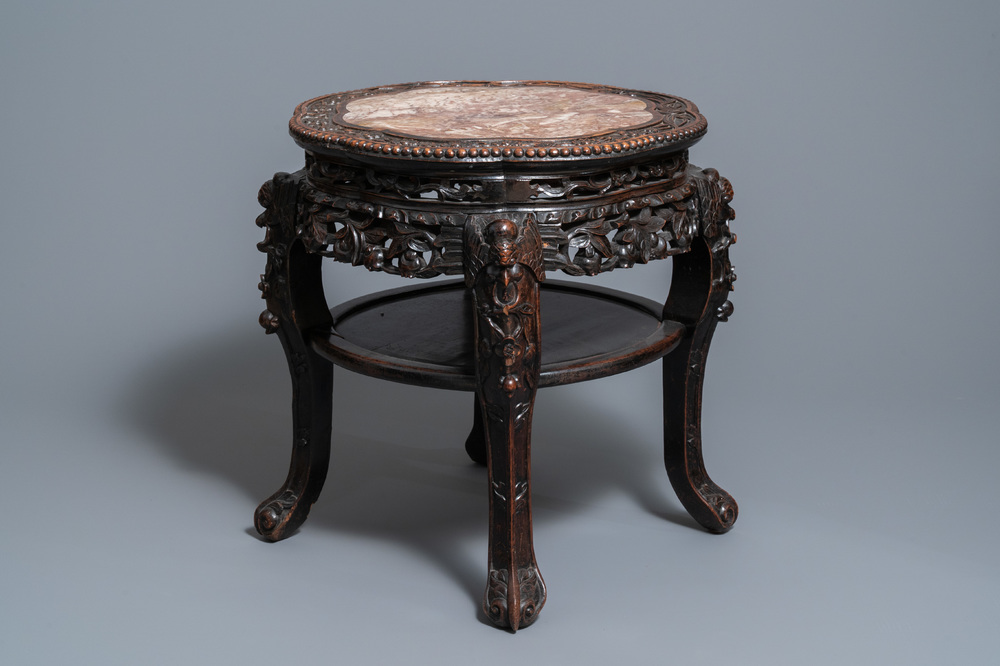 A Chinese carved wooden marble top stand, 19th C.