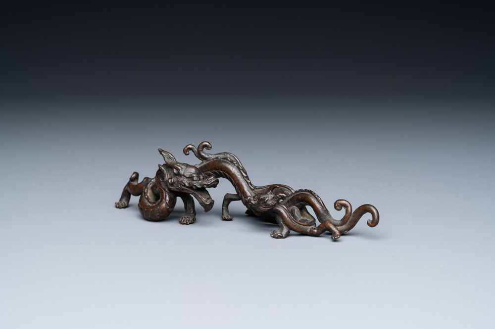 A rare Chinese bronze 'dragon' brush rest, Yuan/Ming