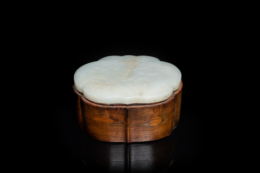A Chinese wooden box with a white jade 'ruyi' plaque as cover, 18/19th C.