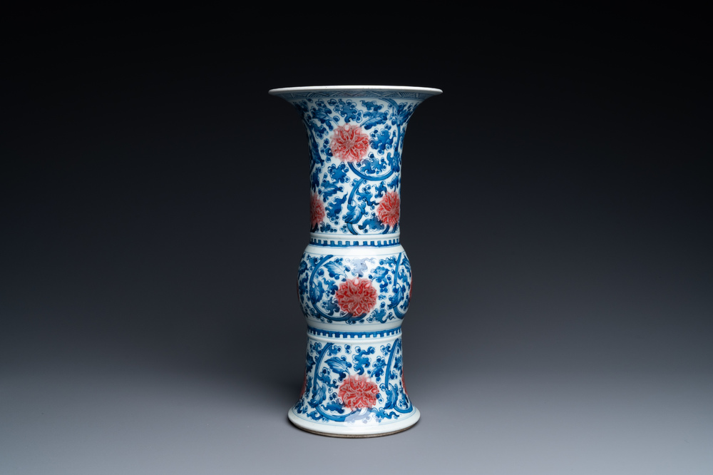 A Chinese blue, white and copper-red 'gu' vase with lotus scrolls, Kangxi