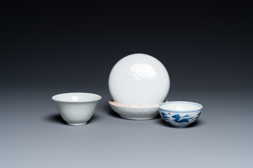 A Chinese white-glazed bowl, a small blue and white bowl and a covered box with incised design, Ming and Qing