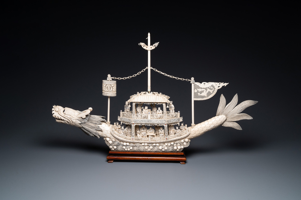 A Chinese carved ivory dragon boat on wooden stand, 19th C.