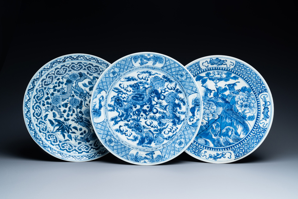 Three Chinese blue and white dishes with dragons, phoenixes and Buddhist lions, 19th C.