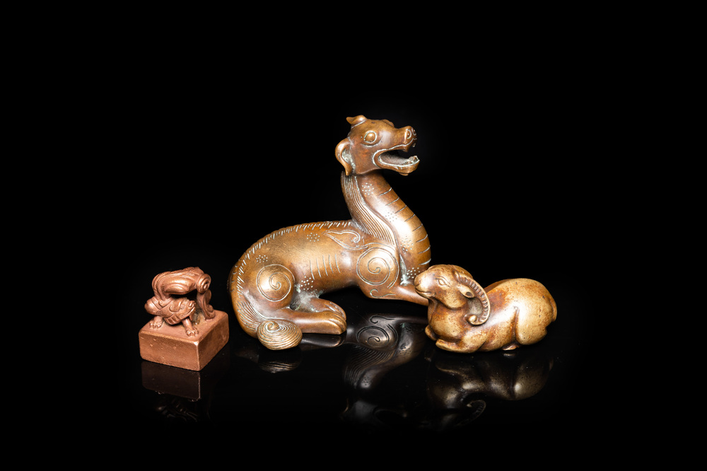 Two Chinese bronze scroll weights and a seal stamp, Qing