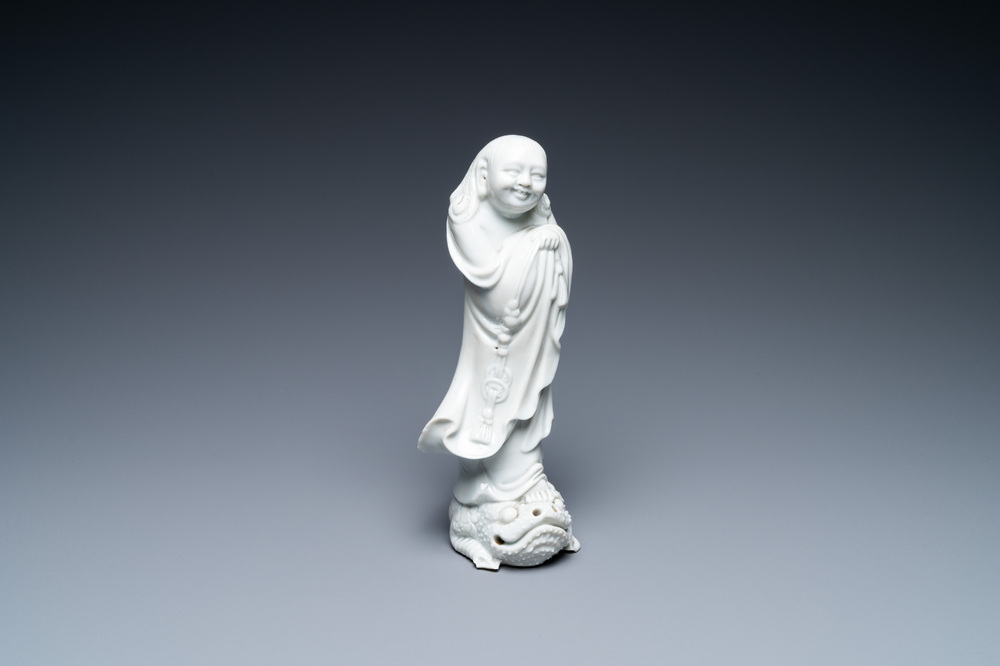 A Chinese Dehua blanc de Chine figure of Liu Hai with the toad, Kangxi