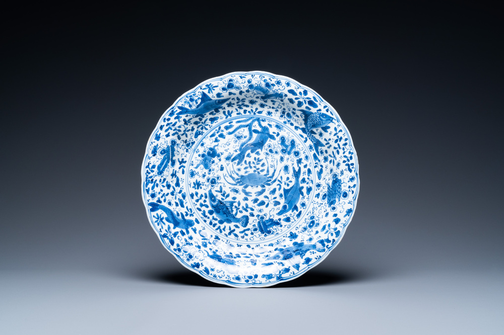 A Chinese blue and white lobed 'crab and fish' dish, Yu mark, Kangxi